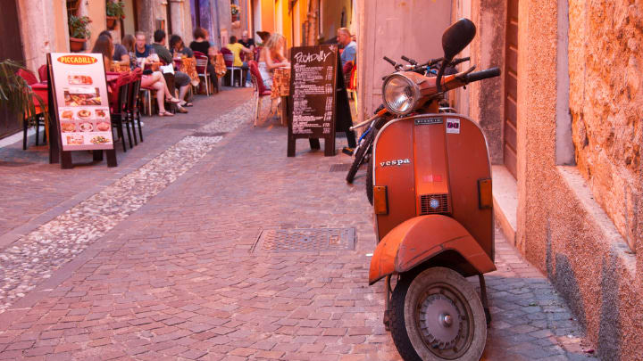 Image of Path, Walkway, Motorcycle, Vehicle, Scooter, Motor Scooter, Chair, Person, Plant, 