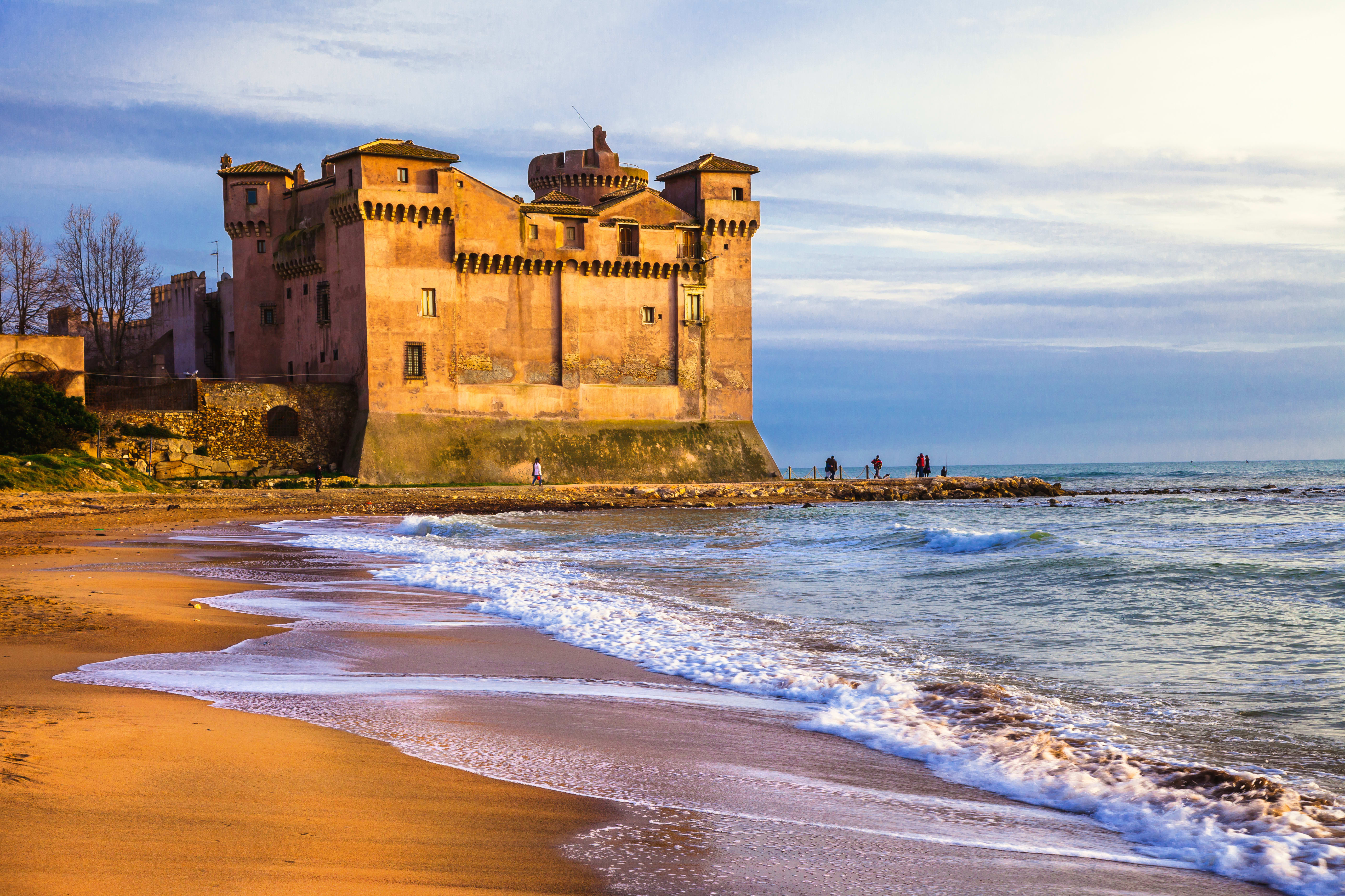 Image of Building, Castle, Fortress, Nature, Outdoors, Sea, Water, Beach, Coast, Shoreline, Person, 