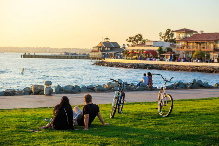 Image of Water, Waterfront, Adult, Male, Man, Person, Outdoors, Shelter, Female, Woman, Bicycle, Vehicle, Nature, Scenery, Summer, Grass, Neighborhood, 