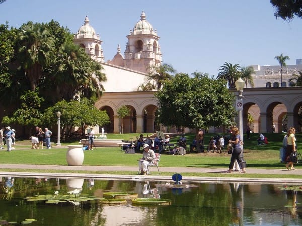 Image of House, Housing, Villa, Grass, Nature, Outdoors, Park, Hacienda, Person, Handbag, Hat, Chair, Pond, Water, Campus, 