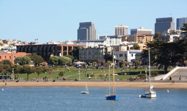 Image of City, Water, Waterfront, Metropolis, Urban, Boat, Sailboat, Vehicle, Downtown, Harbor, Pier, Cityscape, Office Building, Neighborhood, Condo, Housing, Outdoors, Grass,