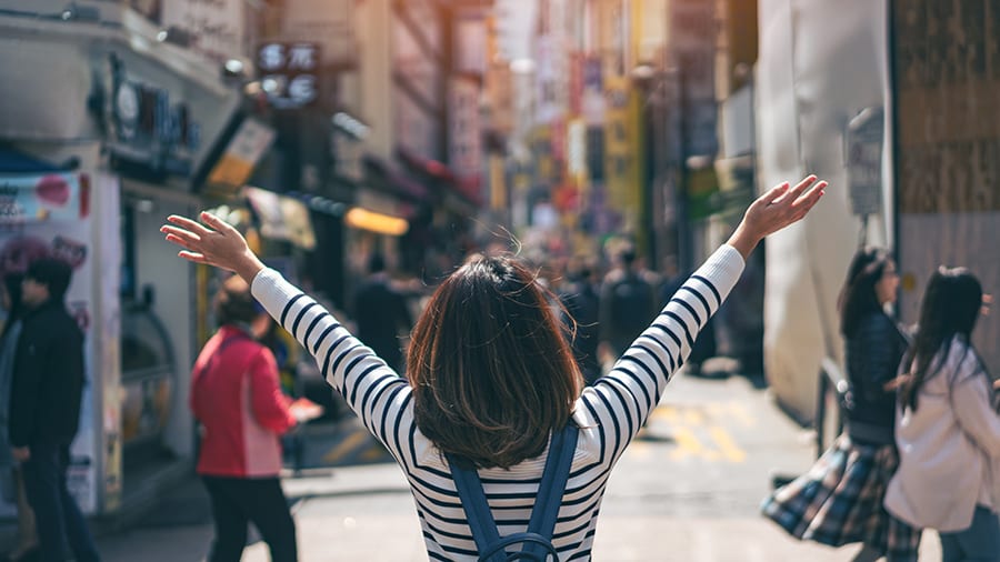 Image of Face, Head, Person, Happy, Female, Girl, Teen, Finger, Hand, Adult, Woman, Bag, Handbag, People, 