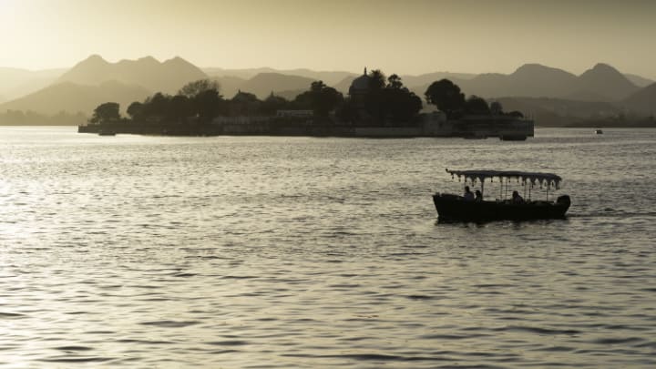 Image of Land, Nature, Outdoors, Sea, Water, Boat, Vehicle, Watercraft, Person, Waterfront, Scenery, Shoreline, Coast, Landscape, Silhouette, 