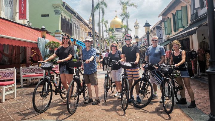 Image of People, Person, Urban, City, Adult, Male, Man, Road, Street, Female, Woman, Bicycle, Vehicle, Chair, Handbag, Shoe, Hat, Neighborhood, Helmet, 