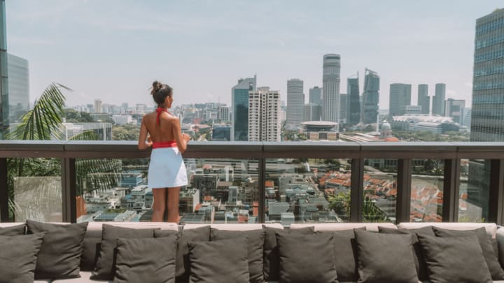 Image of City, Balcony, Cityscape, Urban, Skirt, Adult, Female, Person, Woman, Couch, Furniture, High Rise, 