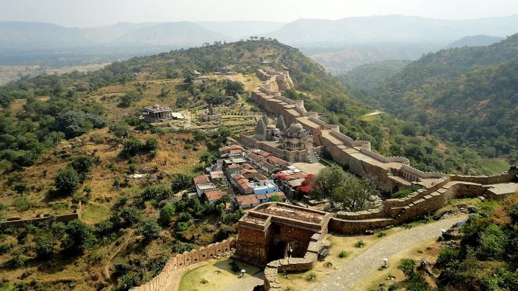 Kumbhalgarh Fort wall and gate winding up the forested Aravalli hillside