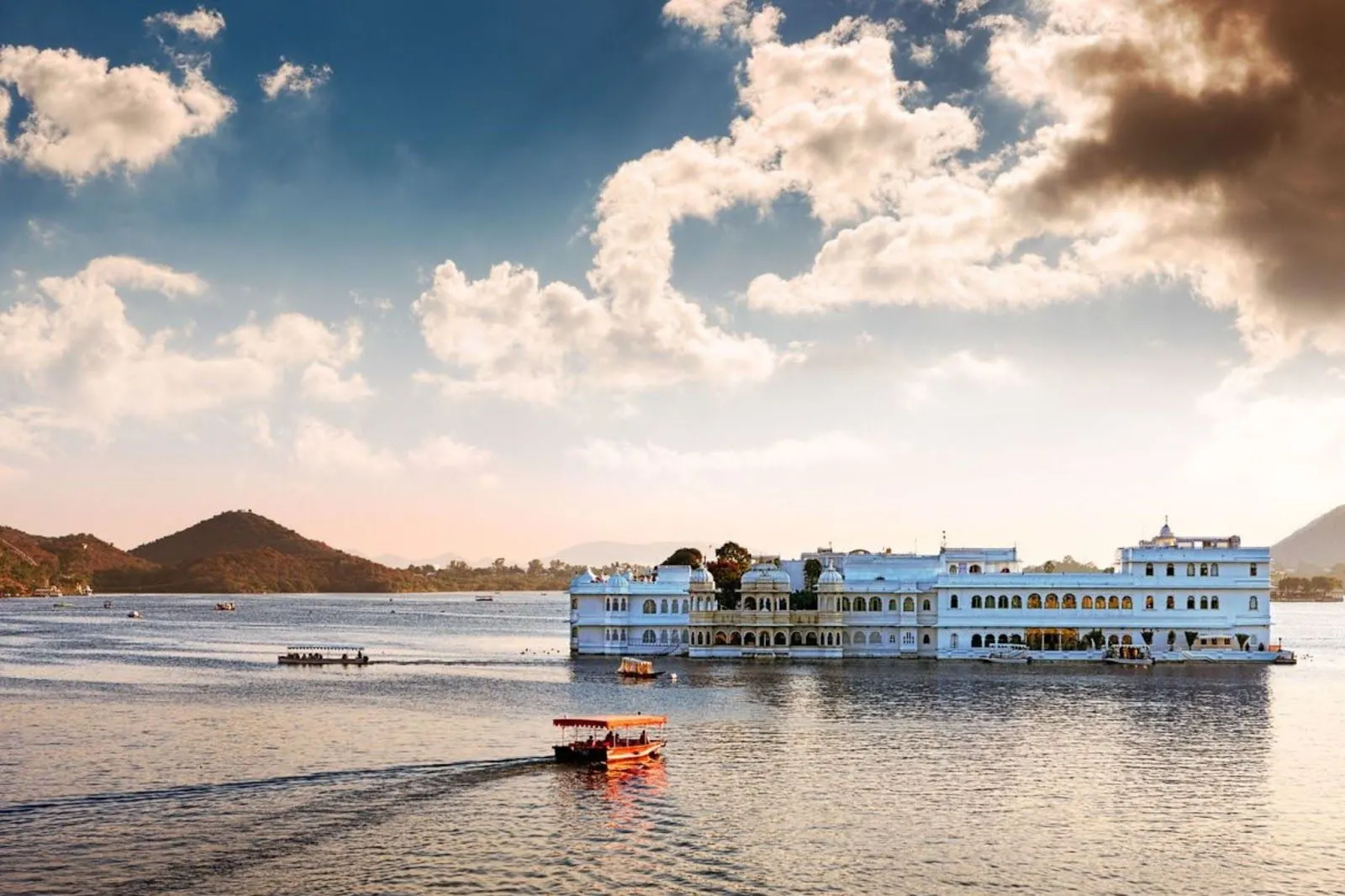 Boat ride on Lake Pichola with City Palace and Lake Palace in the background, Udaipur