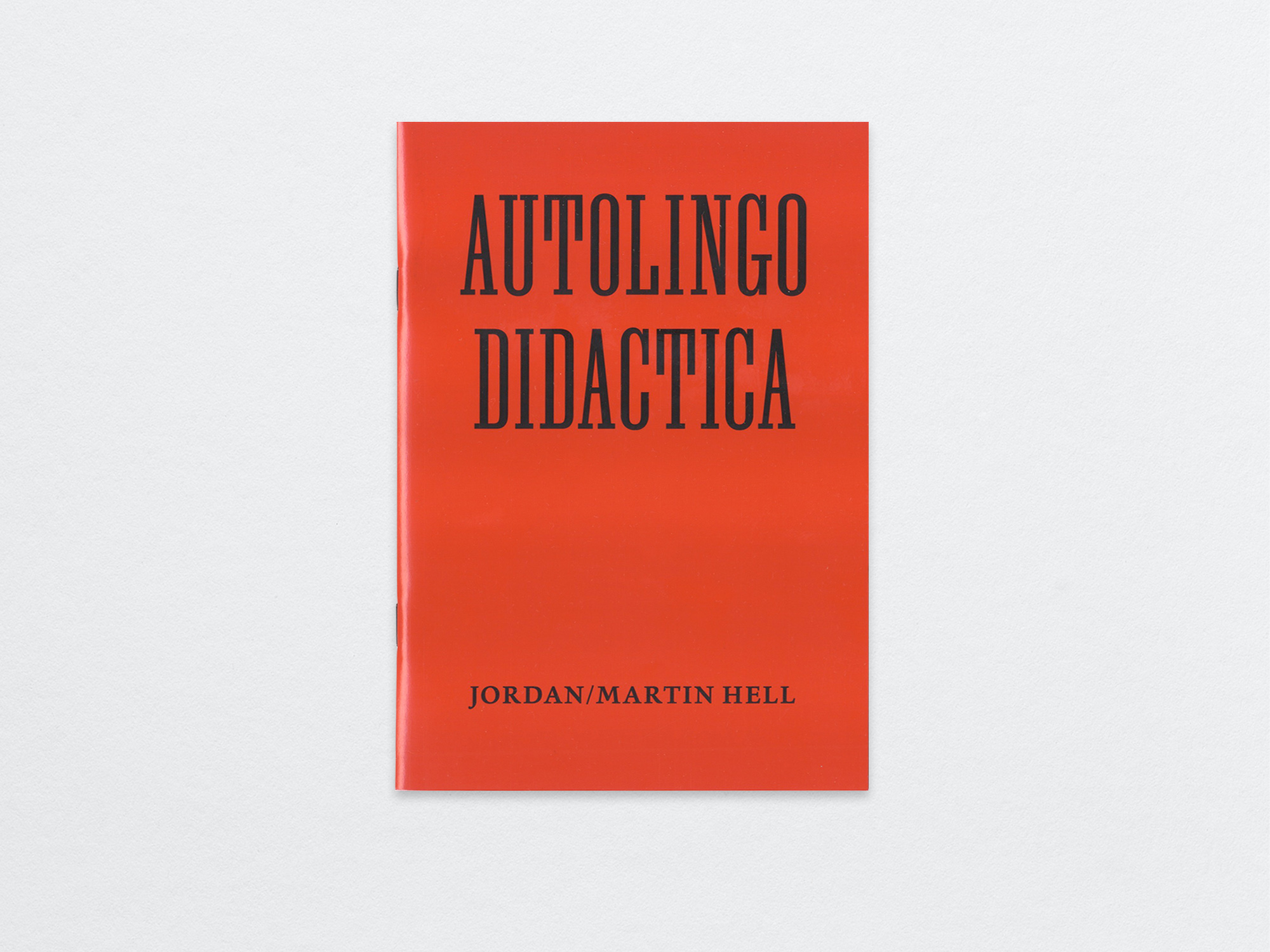 Red booklet with black typography