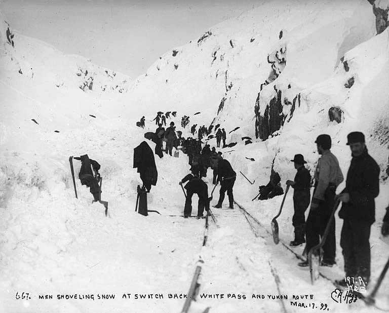 Clearing the tracks of the White Pass & Yukon Railroad after a snow storm, Alaska, March 17, 1899
