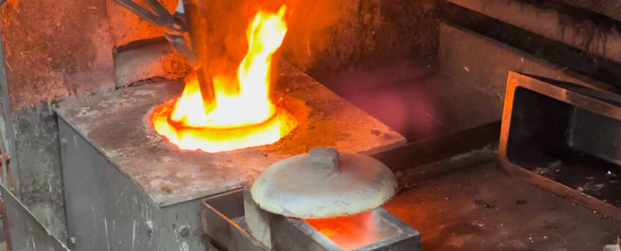 A furnace with a white hot crucible, full of gold