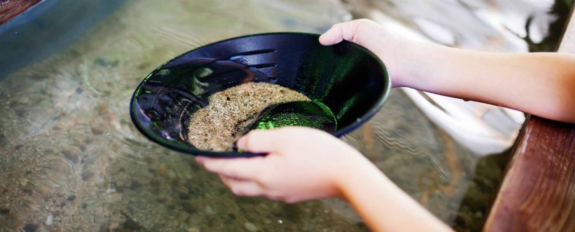 Panning for gold, using a plastic pan