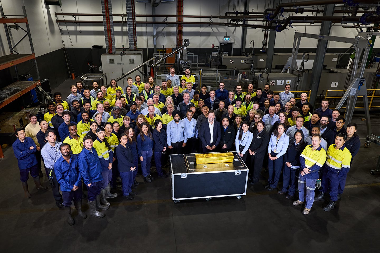 Photo of the world's largest gold bar at The Perth Mint and the team responsible for its creation