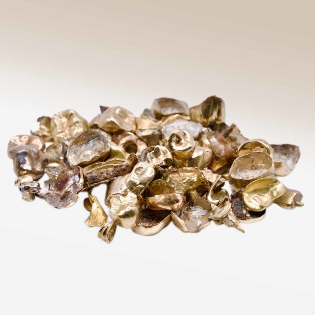 A pile of scrap gold dental crowns