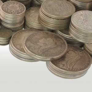 Piles of UK pre-decimal silver coins