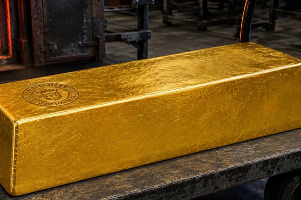 A huge gold bar on an industrial trolley
