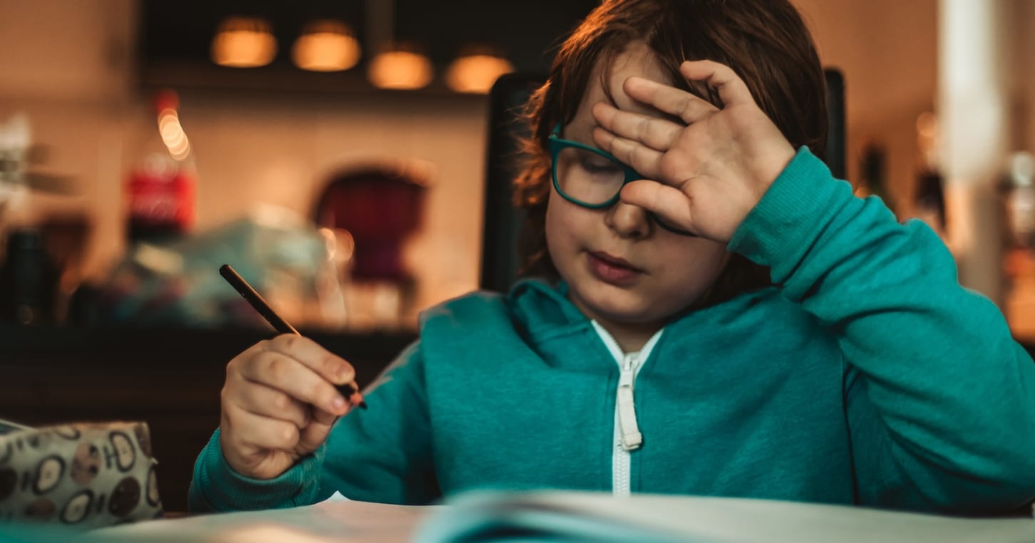 A boy struggling to do his homework