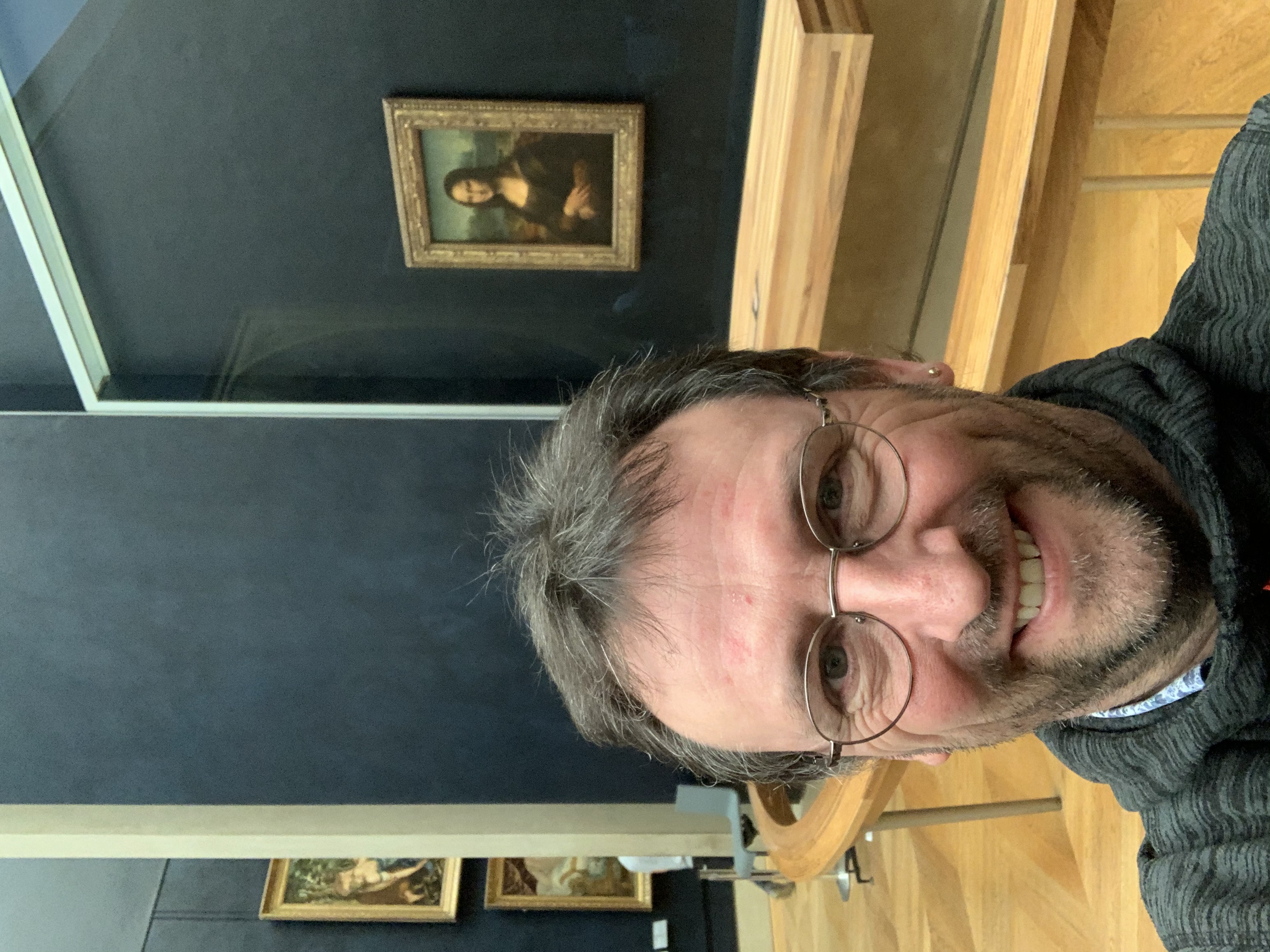 The Mona Lisa in the background at Le Louvre