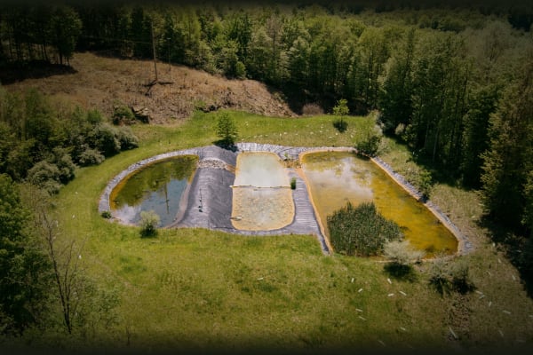 Arial photograph of three ponds located in a forest