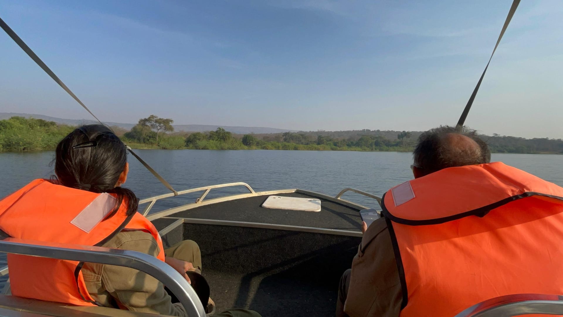 Guests in orange life jackets on a boat trip on Lake Ihema in Akagera National Park