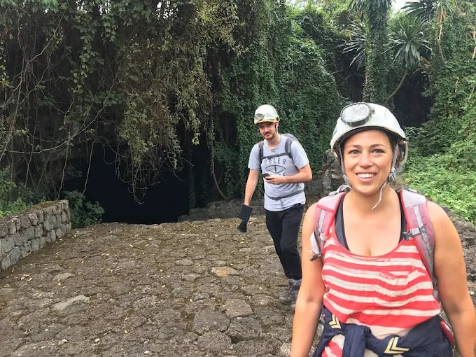 Visitors in helmets at the entrance of the Musanze caves near Volcanoes National Park
