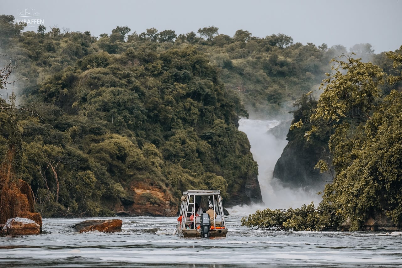 A tour boat in the river in front of Murchison Falls