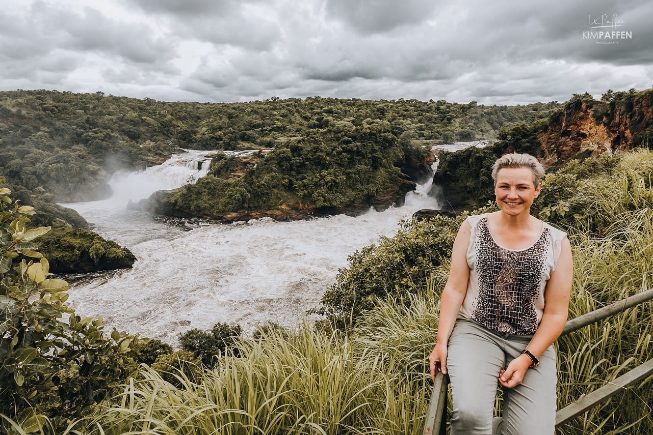 A woman standing at a viewpoint above Murchison Falls