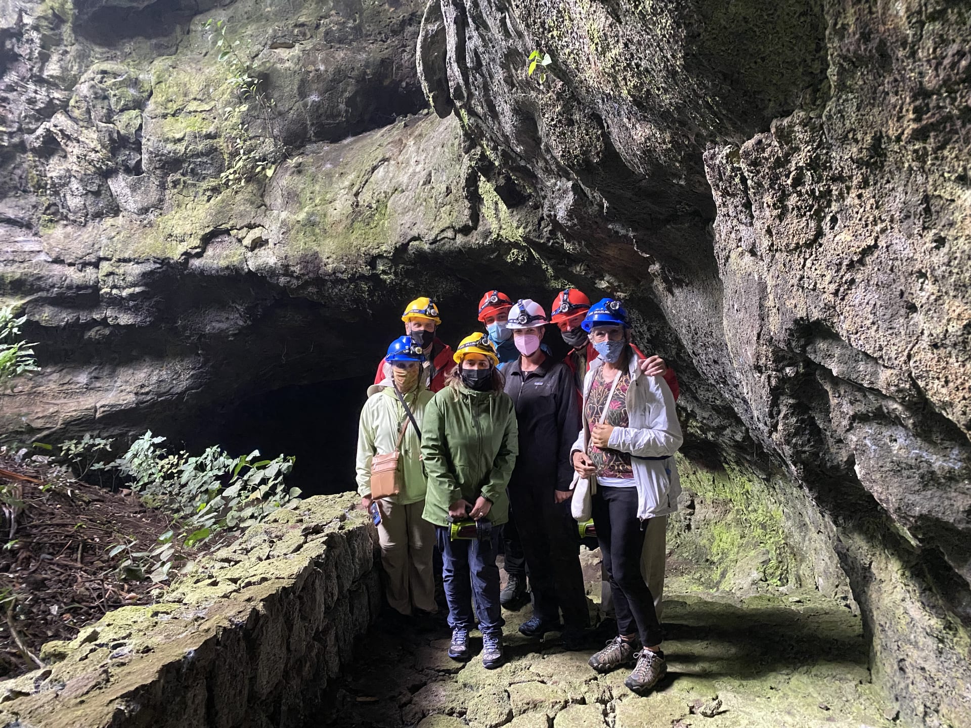 A group of visitors with headlamps inside the Musanze caves near Volcanoes National Park