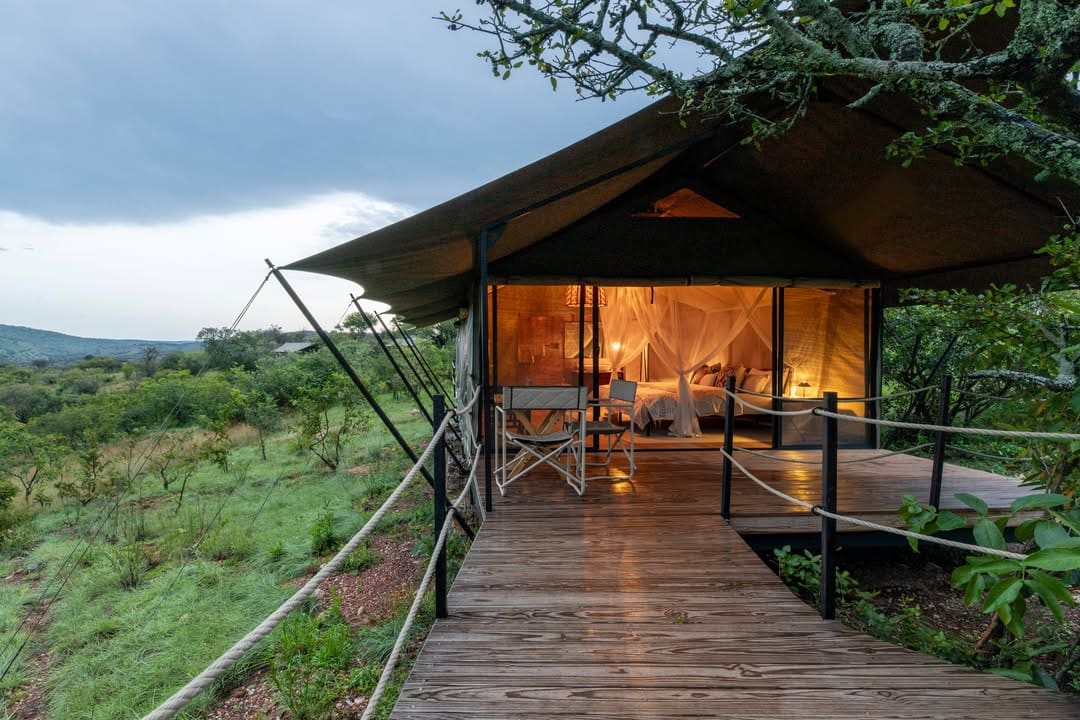 A tented lodge with a wooden deck above Lake Ihema in Akagera National Park, Rwanda