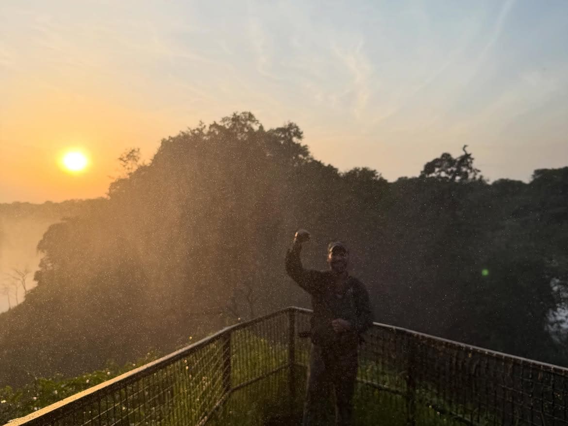 A guest at a lookout watching the sun set over the Nile at Murchison Falls National Park
