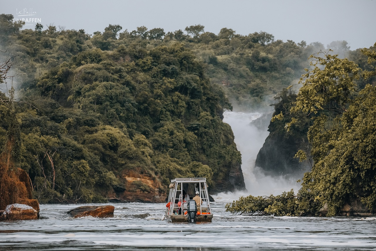 A tour boat in the river in front of Murchison Falls