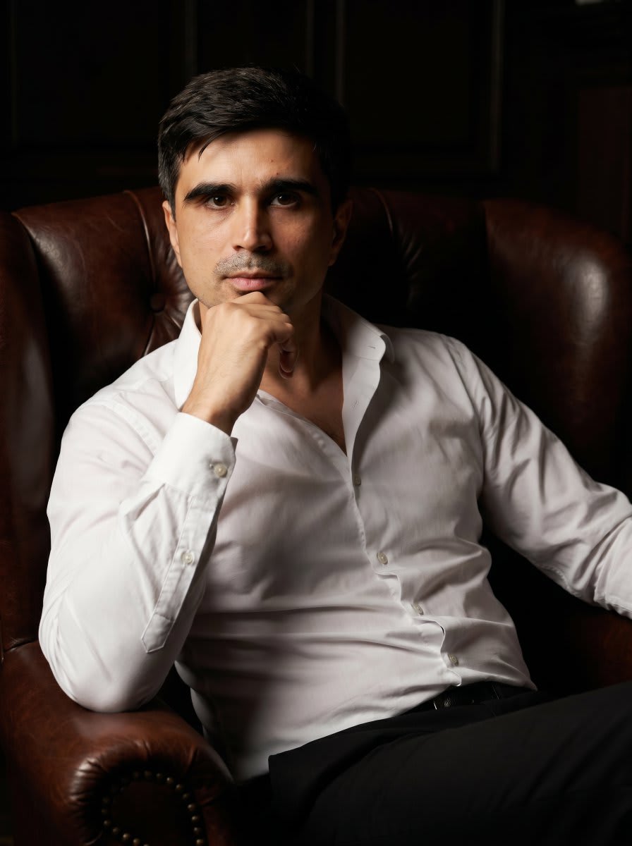 Professional Executive Portrait in Armchair – man in a dress, AI image made with Nano Banana Pro