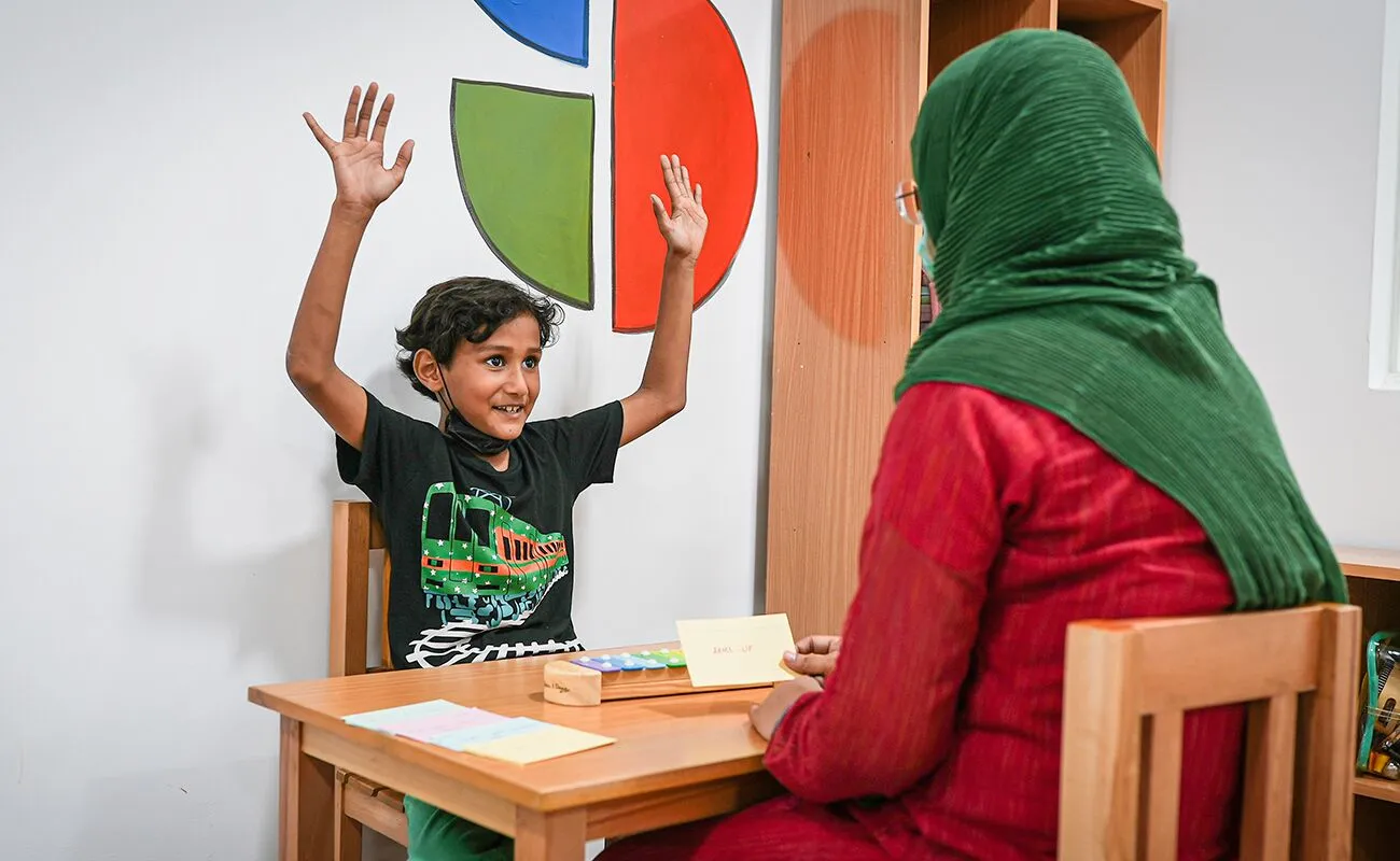 Speech therapist using picture cards for communication practice