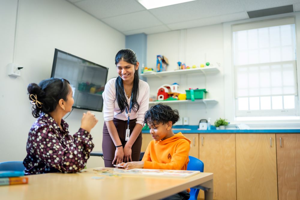 ABA therapist working one-on-one with a child at a table
