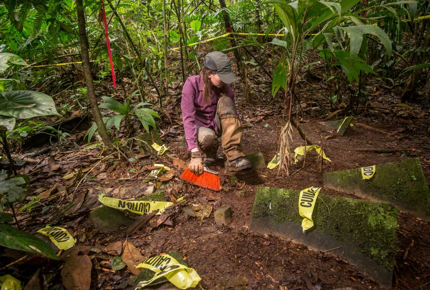 In the tropical rainforests of Mosquitia, Honduras, this graduate student of anthropology works around yellow tape markers to uncover a cache of over 50 artifacts that may help us learn more about the former human inhabitants of the area.