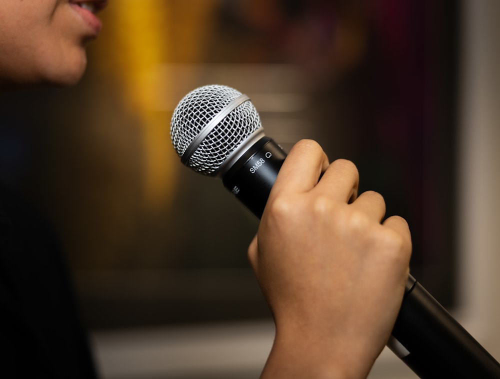 A closeup of a person speaking into a microphone