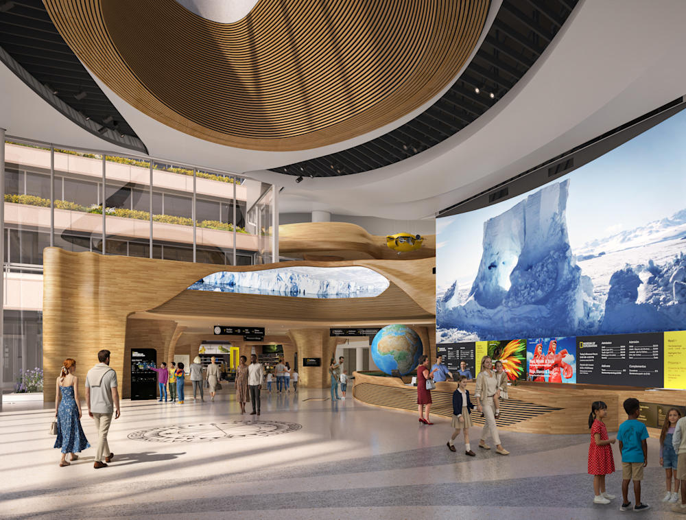 A rendering of the museum's pavilion interior that includes the front desk in front of a large media wall. 