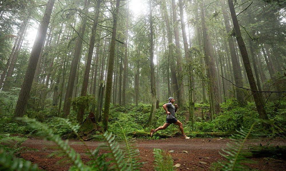 Man running through a forest