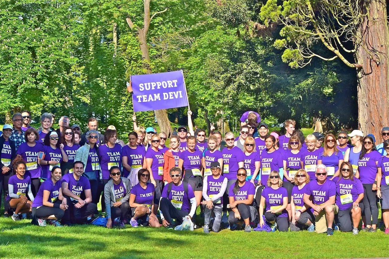 Devi Ralla surrounded by friends and family who rallied to run in the BMO Vancouver Marathon in her honour