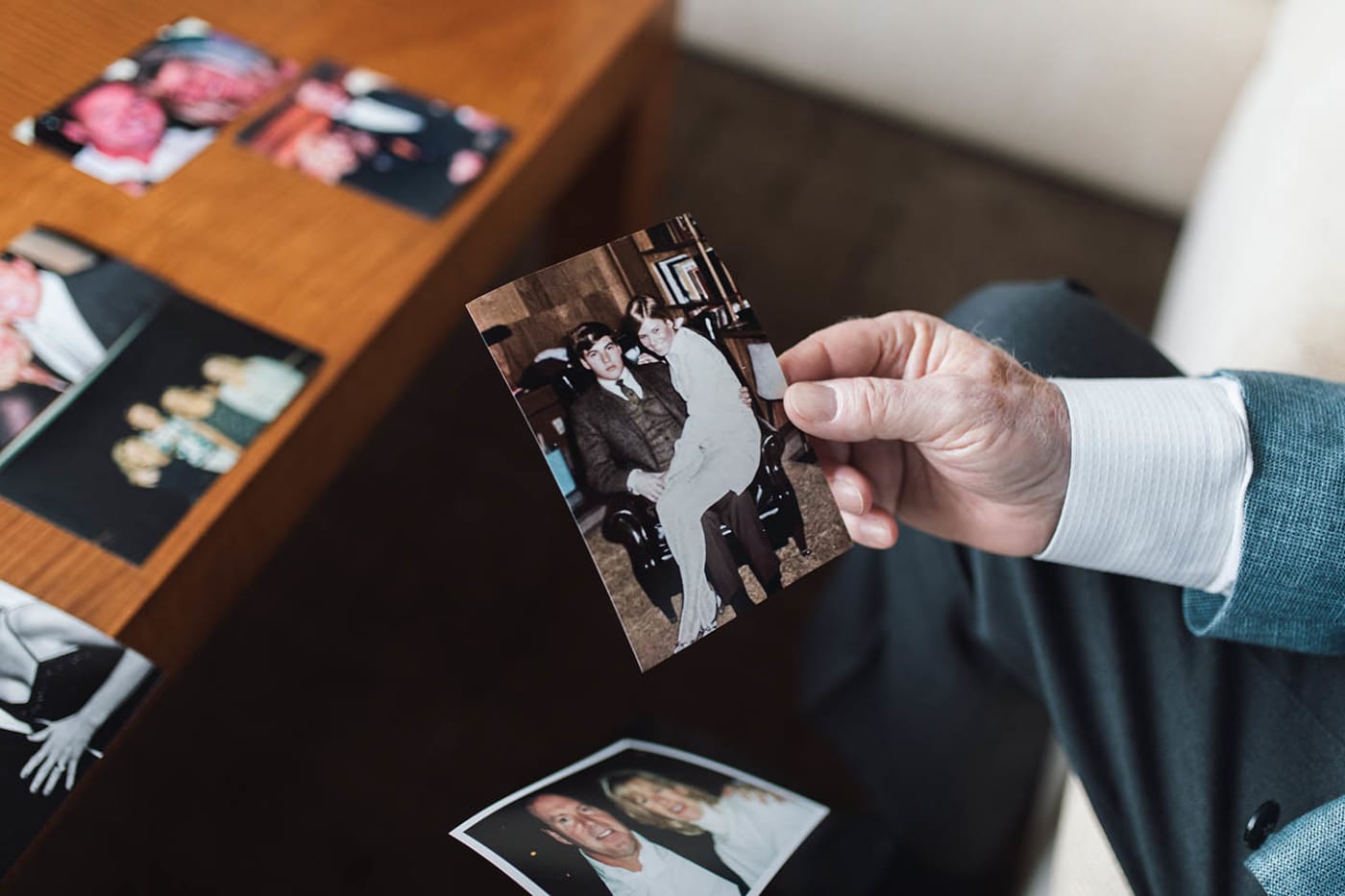 Roger Gouin holding an old photo of himself and Peggy Gouin