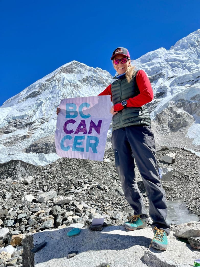 Heather Geluk showing her support of BC Cancer banner from Everest Base Camp