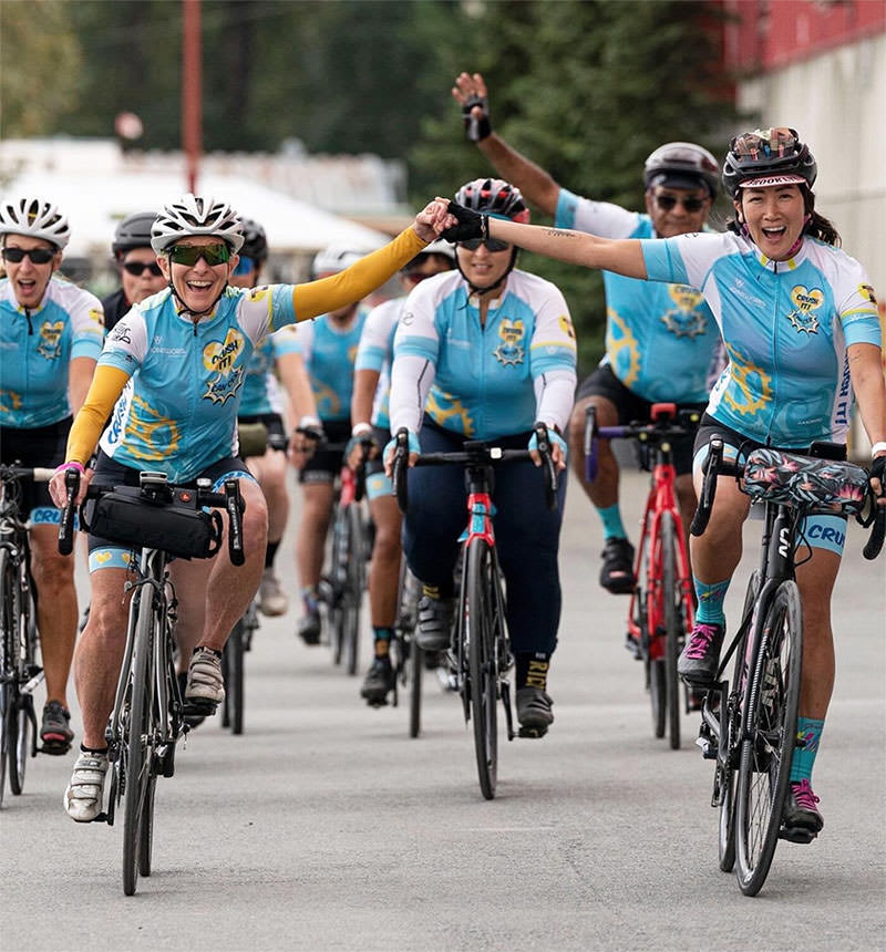 Carmen crosses the Tour de Cure finish line in 2022 with her team Crush It.