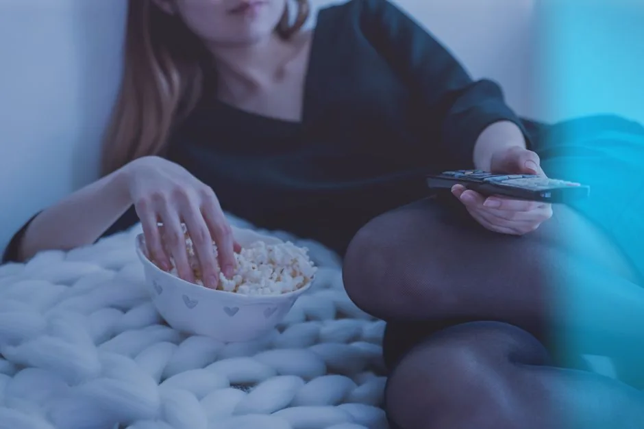 A person watching a drama on TV at home