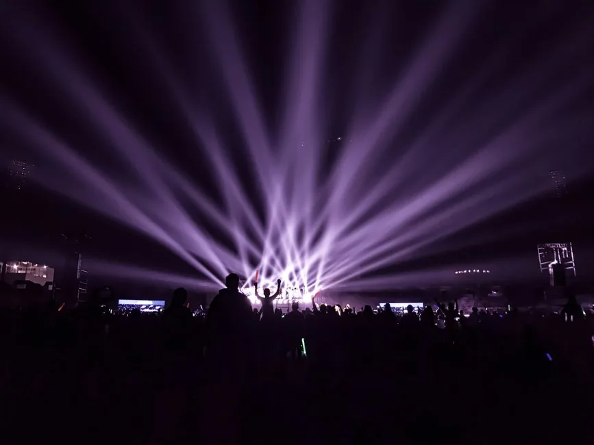 A K-pop performance stage with lights