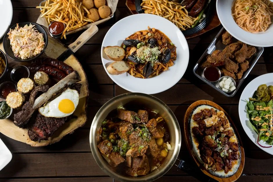 A spread of Korean dishes on a table including rice bowls and stew