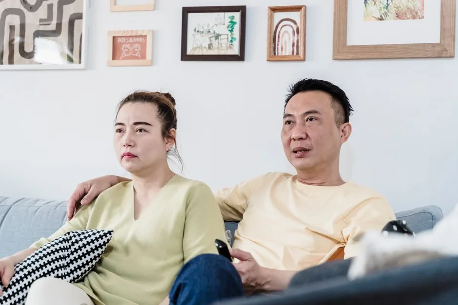 Two people watching a Korean drama on a cozy sofa