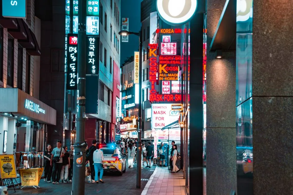 A busy, well-lit Korean street at night