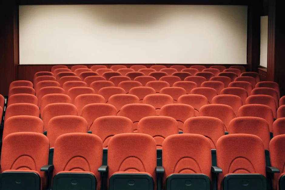 A darkened cinema, screen glowing