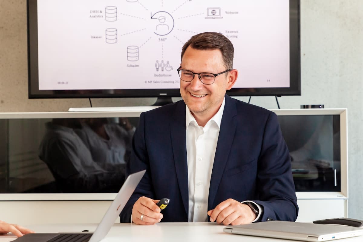 Corporate executive reviewing data charts on a screen in Berlin