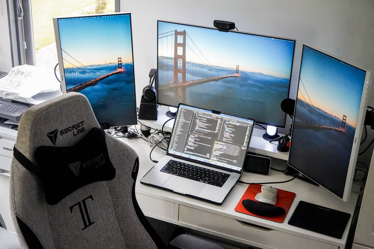 High productivity workspace with multiple monitors and AI interfaces