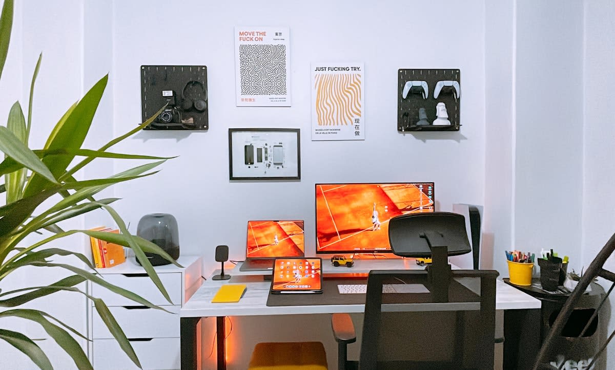 modern minimal home office with multiple monitors showing data dashboards